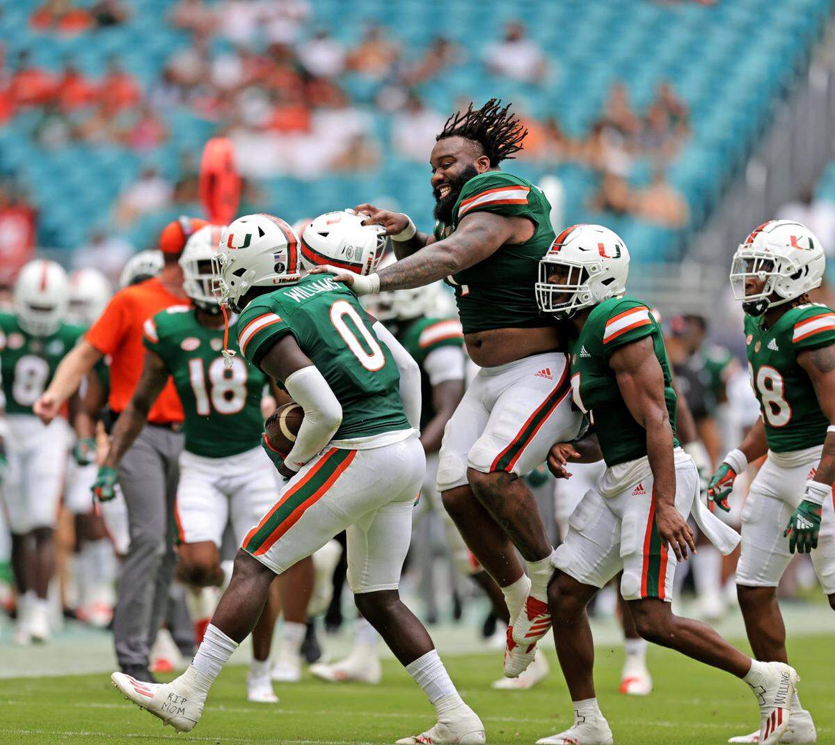 Miami Hurricanes safety James Williams (0) is congratulated by Hurricanes defensive lineman Nesta Jade Silvera (1) after a interception against the Central Connecticut State Blue Devils during the third quarter of their ACC football game at Hard Rock Stadium on Saturday, September 25, 2021 in Miami Gardens, Florida.