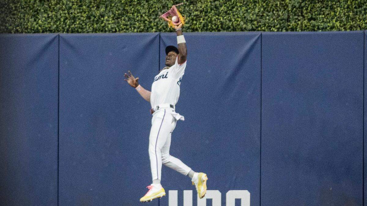 Miami Marlins center fielder Jazz Chisholm Jr. (2) jumps to catch a ball during the first inning of a baseball game on Sunday, Sept. 17, 2023, at loanDepot Park in Miami, Fla. 