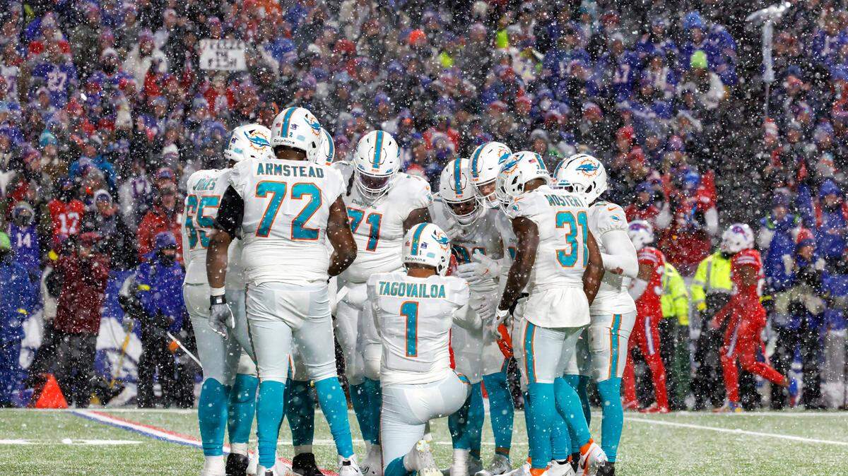 Miami Dolphins quarterback Tua Tagovailoa (1) huddle during fourth quarter of an NFL football game against the Buffalo Bills at Highmark Stadium on Saturday, December 17, 2022 in Orchard Park, New York.