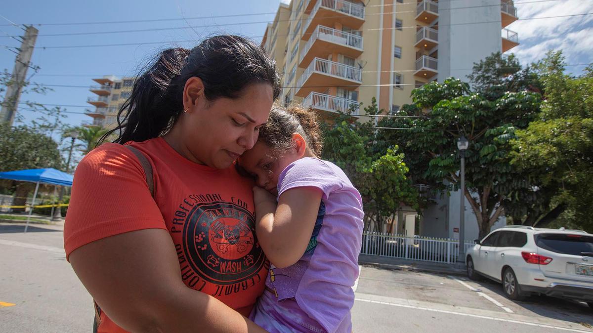 Crestview Towers Condominium resident Ramaxel Gimenez and her daughter Emiliana Gimenez, 3, attend a press conference at the building in North Miami Beach on Thursday, July 8, 2021, for an update on the condo that had been closed days earlier. New legislation in Miami-Dade County requires owners of buildings — including condo associations — to cover housing costs of displaced residents if neglected maintenance caused the building to be closed.