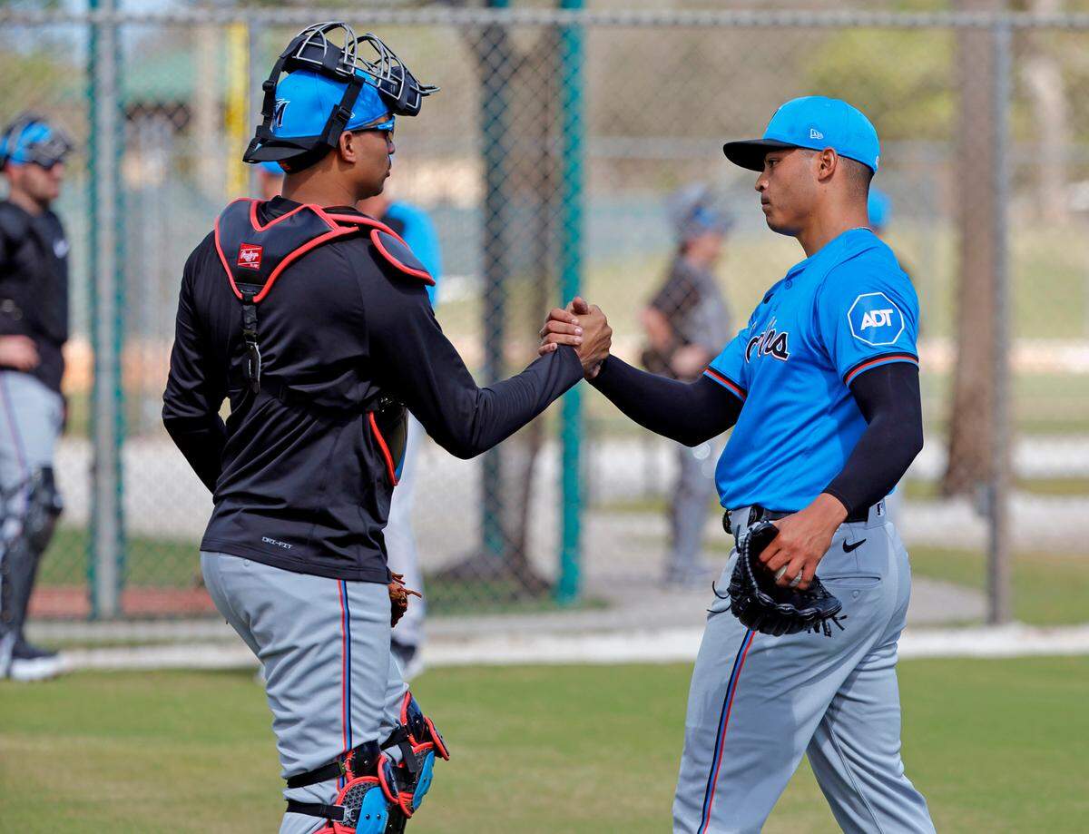 Miami Marlins catcher Christian Bethancourt (left) and left-handed pitcher Jesus Luzardo greet each other after a bullpen session during the Marlins’ first pitchers and catchers spring training workout at Roger Dean Chevrolet Stadium in Jupiter, Florida on Thursday, February 15, 2024.