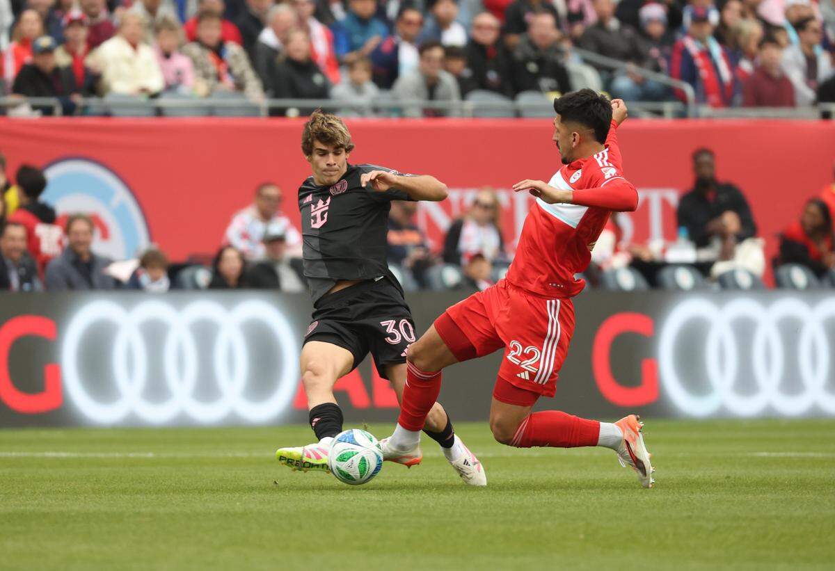 Apr 13, 2025; Chicago, Illinois, USA; Chicago Fire FC defender Mauricio Pineda (22) and Inter Miami CF midfielder Benjamin Cremaschi (30) battle for control of the ball during the first half at Soldier Field. Mandatory Credit: Talia Sprague-Imagn Images