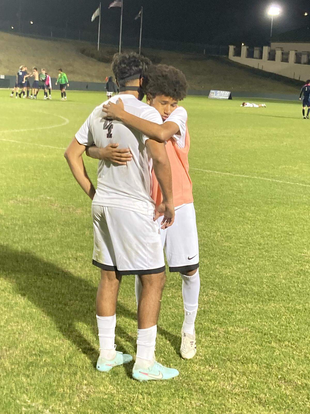 Pembroke Pines Charter’s Arjun Nambiarr (4) is consoled by a teammate following their 2-1 overtime loss against Beachside Saturday night at Spec Martin Stadium in DeLand, Fla.