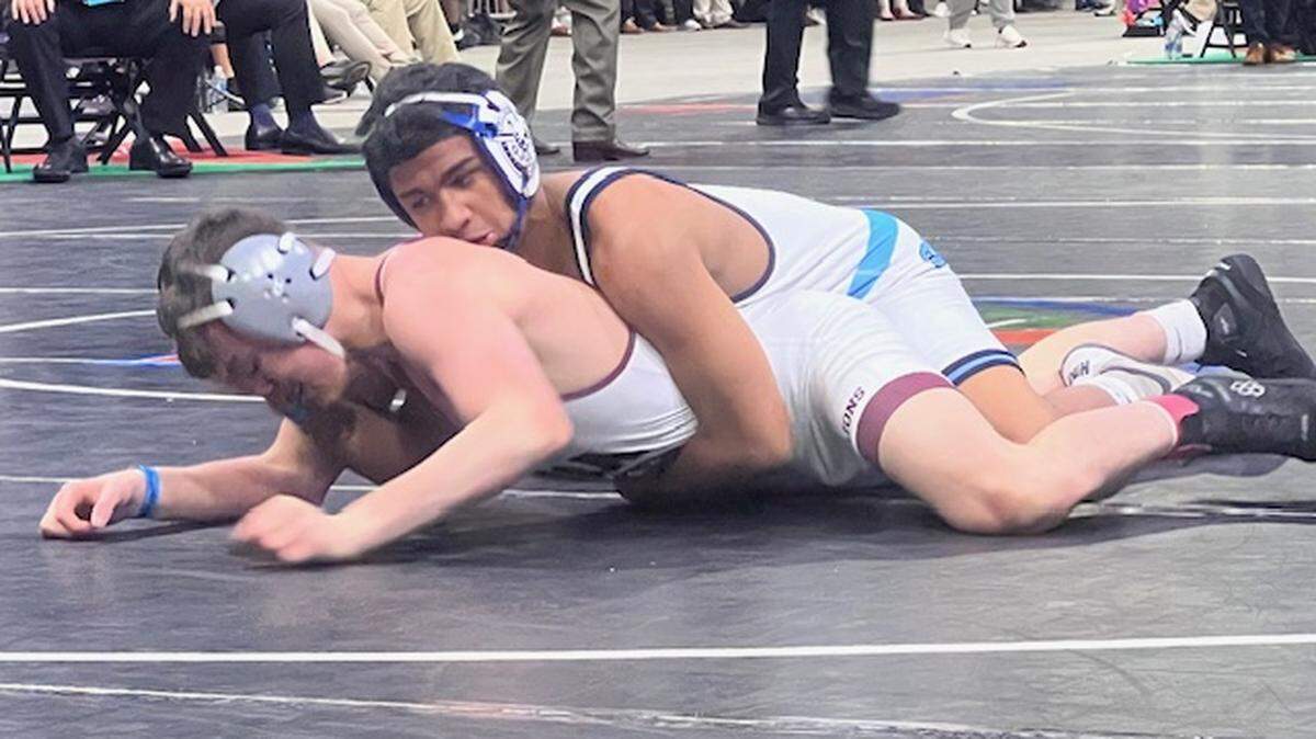 Somerset Academy’s Jovani Solis battles Naples First Baptist’s Jonathan Moder in the Class 1A 132-pound weight class state championship bout on Saturday in Kissimmee, Fla.