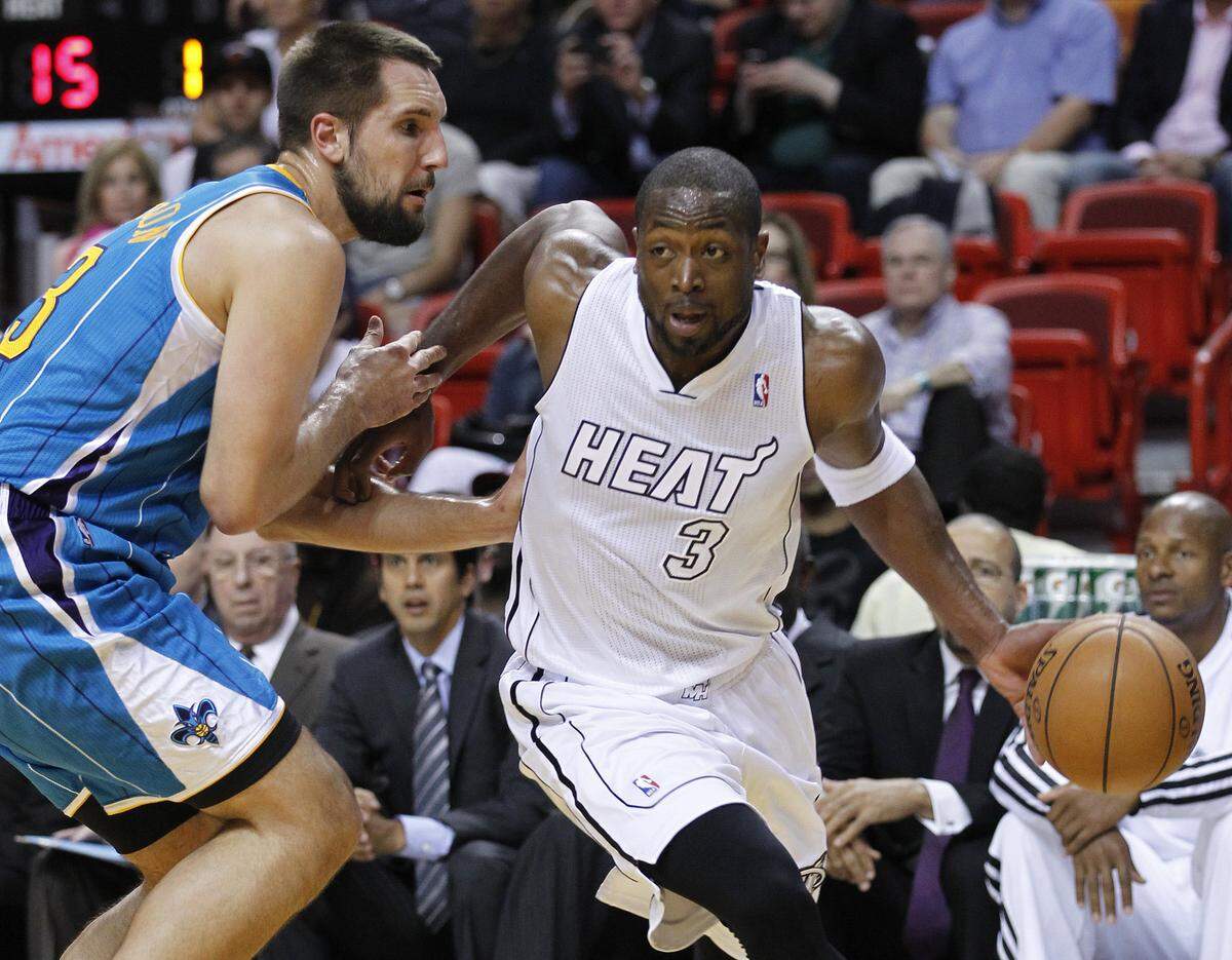 Miami Heat guard Dwyane Wade (3) drives past New Orleans Hornets forward Ryan Anderson during the first half of an NBA basketball game, Saturday, Dec. 8, 2012 in Miami. Anderson scored 24 points and Wade scored 26 as the Heat defeated the Hornets 106-90.