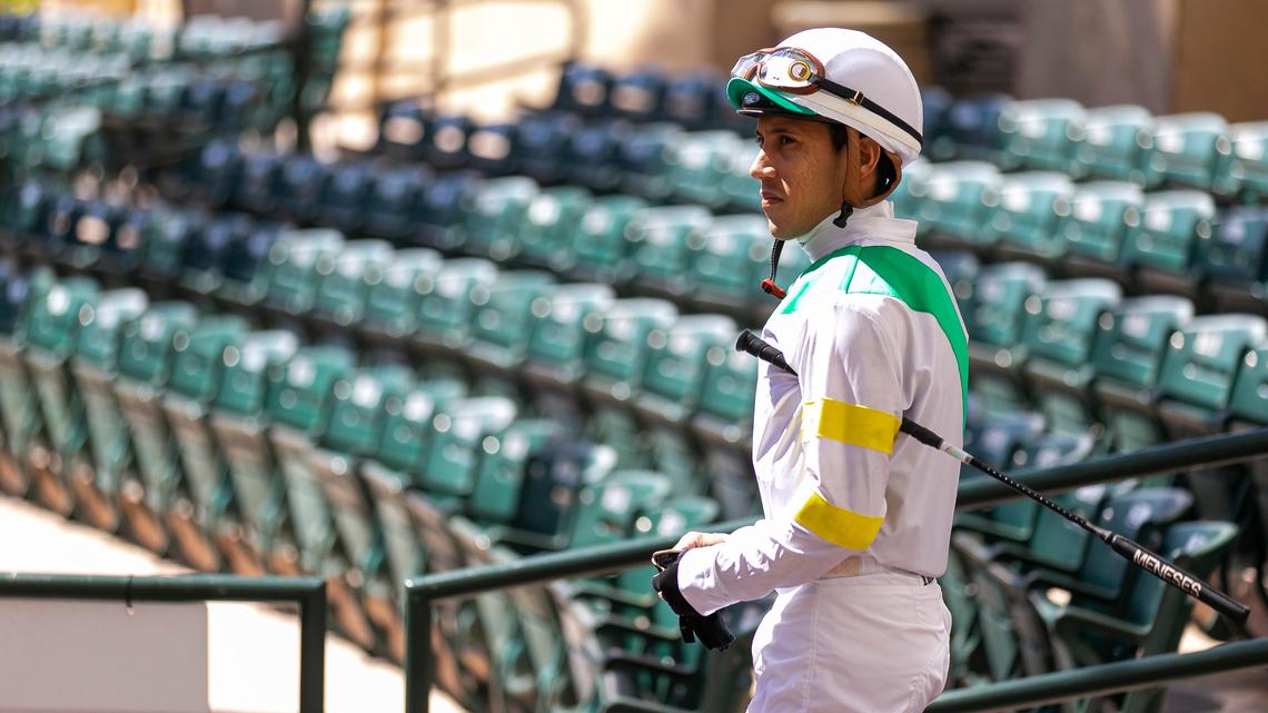 Horse Jockey Marcos Meneses makes his way to the paddock walking ring before a race at Gulfstream Park Racing and Casino in Hallandale Beach, Florida on Friday, March 13, 2020. Organizers have decided to continue racing horses but are preventing fans from attending the event due to fears of possible COVID-19 transmissions.