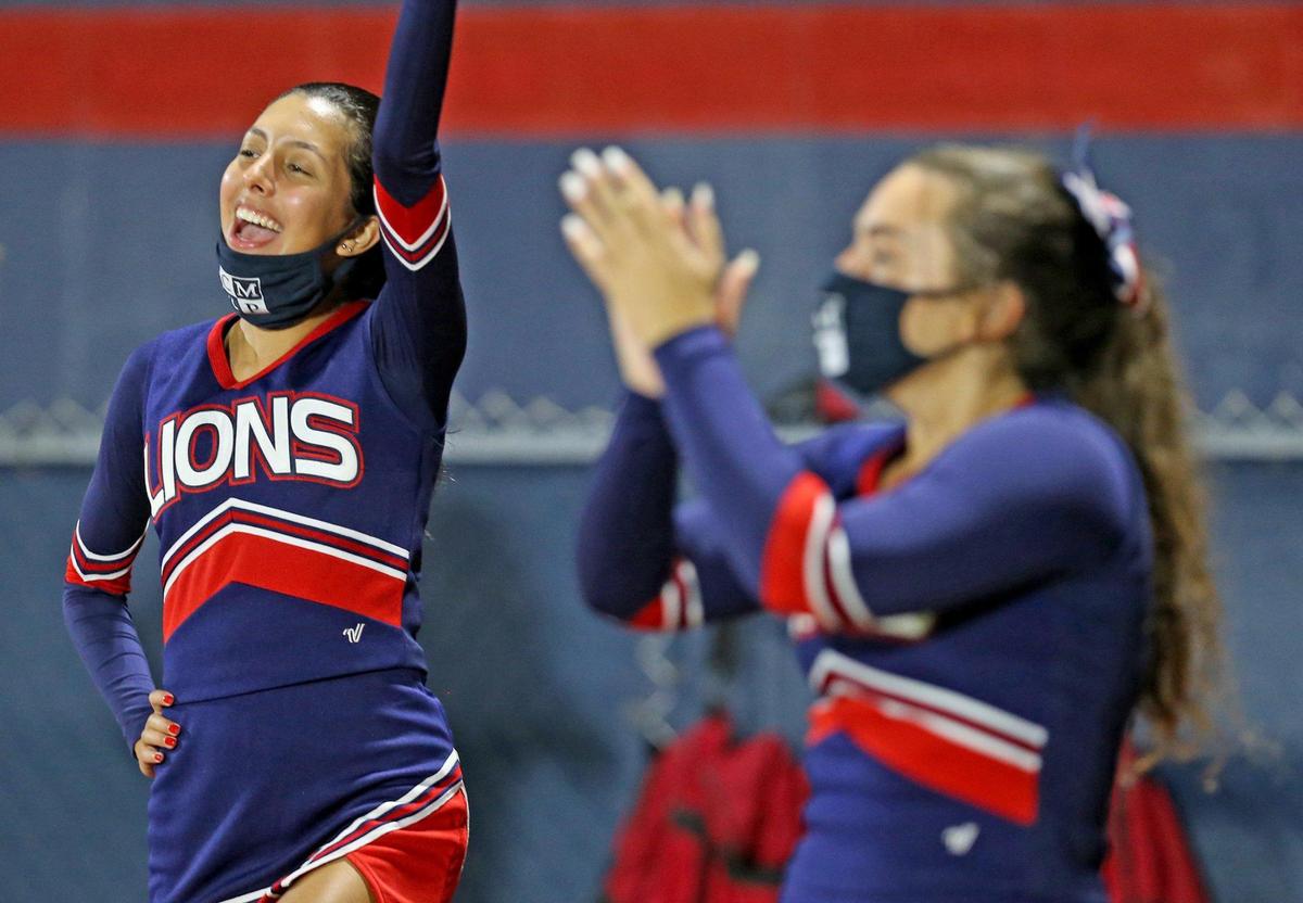 Chaminade-Madonna cheerleaders perform with mask as they play Champagnat Catholic at Chaminade-Madonna College Preparatory School, Hollywood, Florida, Friday, September 11, 2020.