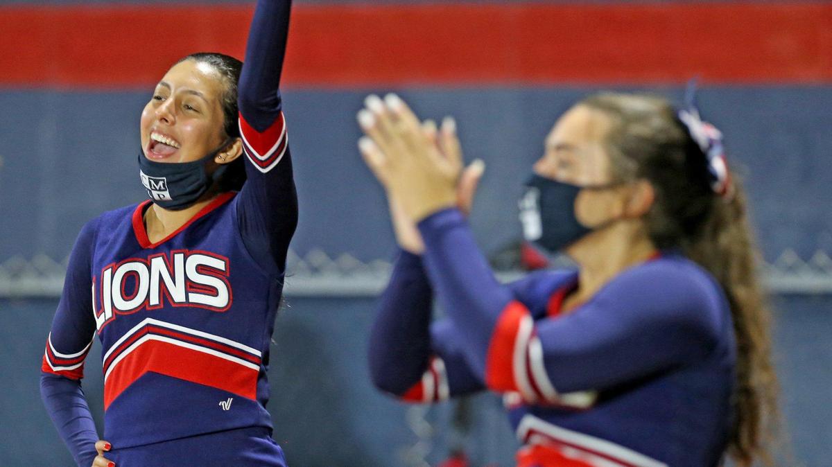Chaminade-Madonna cheerleaders perform with masks as they play Champagnat Catholic at Chaminade-Madonna College Preparatory School, Hollywood, Florida, Friday, September 11, 2020.