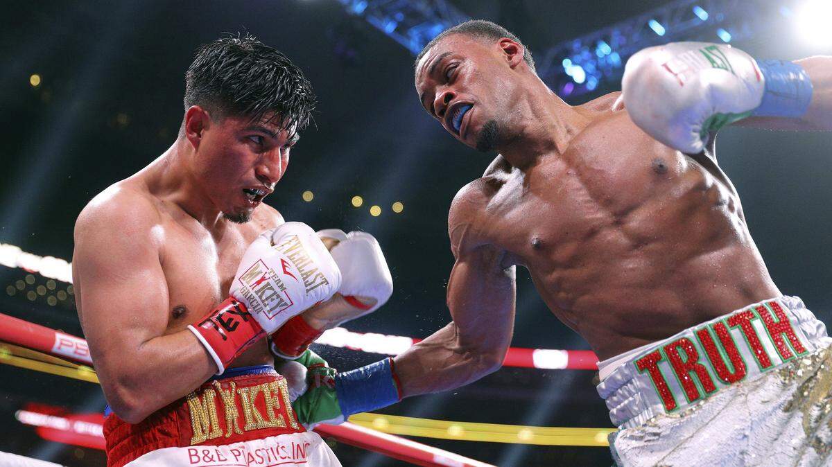 Mikey Garcia, left, takes a blow to the body from Errol Spence Jr. during the ninth round of the IBF welterweight championship boxing bout Saturday, March 16, 2019, in Arlington, Texas. (AP Photo/Richard W. Rodriguez)