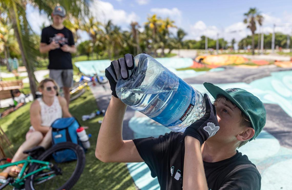 Aaron McElwain, 13, drinks some water after riding his scooter at Haulover Skateboard Park on June 14, 2023, in Miami Beach. That day Miami-Dade County issued a heat advisory for residents after the National Weather Service estimated the heat index would reach between 105 and 108 degrees.
