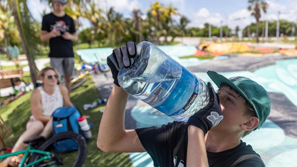 Aaron McElwain, 13, drinks some water after riding his scooter at Haulover Skateboard Park on Wednesday, June 14, 2023, in Miami Beach, Fla. Miami-Dade County issued a heat advisory for residents after the National Weather Service estimated the heat index would reach between 105 and 108 degrees.