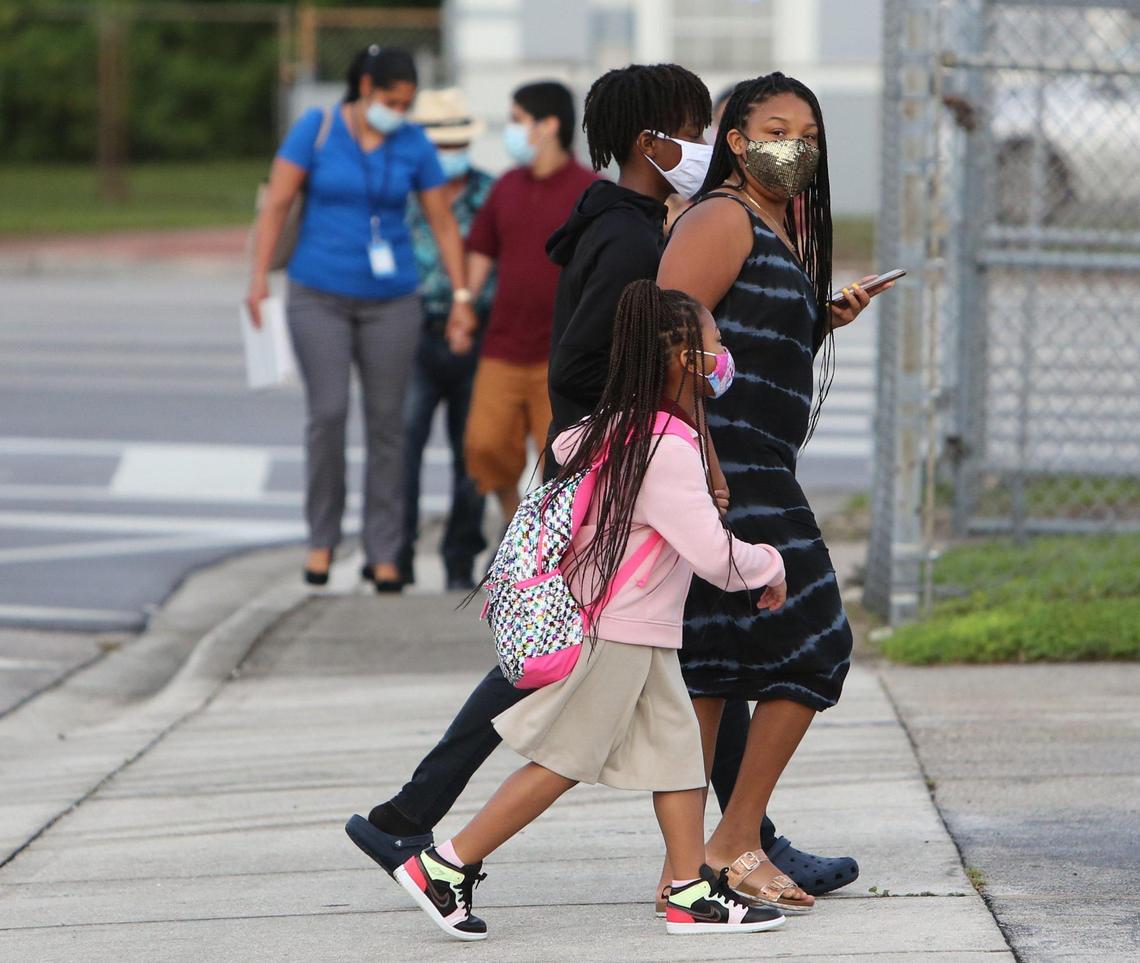In Miami-Dade County students in pre-K, kindergarten and first grade were welcomed back to schools Monday, October 5, 2020. Willow Williams, 6, holds hands with her mother Frantasha Williams as they make their way to school at Carrie P. Meek/Westview K-8 along with Frantasha’s brother, Fredrick Williams,14. Fredrick will begin classes at the school on Friday.