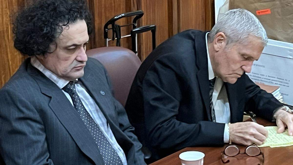 Jose Rojas, seated to the left of defense attorney Jimmy Dellafera, is trying to avoid a death sentence by convincing a jury he was insane when he murdered two Coral Gables co-workers in an office more than a decade ago.