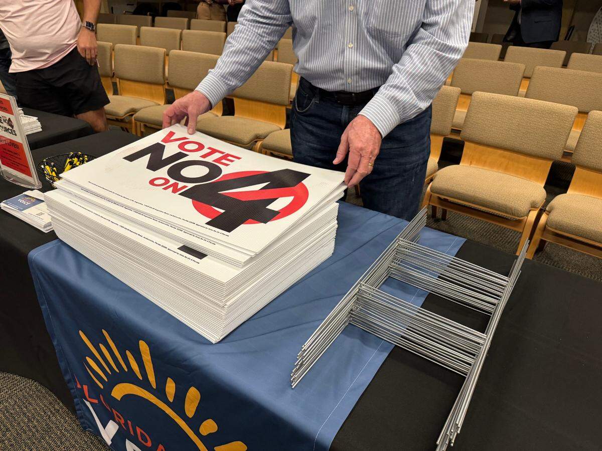 Opponents of Amendment 4, an abortion-access amendment to the state Constitution, distribute “Vote no on 4” yard signs at an event in Tallahassee on Oct. 14.