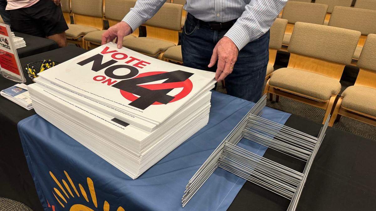 Opponents of Amendment 4, an abortion-access amendment to the state Constitution, distribute “Vote no on 4” yard signs at an event in Tallahassee on Oct. 14.