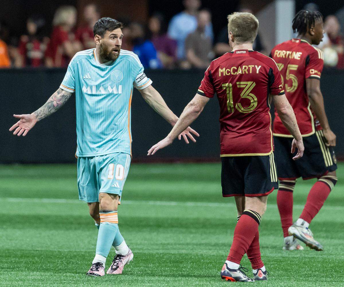 Inter Miami forward Lionel Messi (10) and Atlanta United midfielder Dax McCarty (13) interact in the first half of match two of their MLS Playoffs series at the Mercedes-Benz Stadium on Saturday, Nov. 2, 2024, in Atlanta, Ga.
