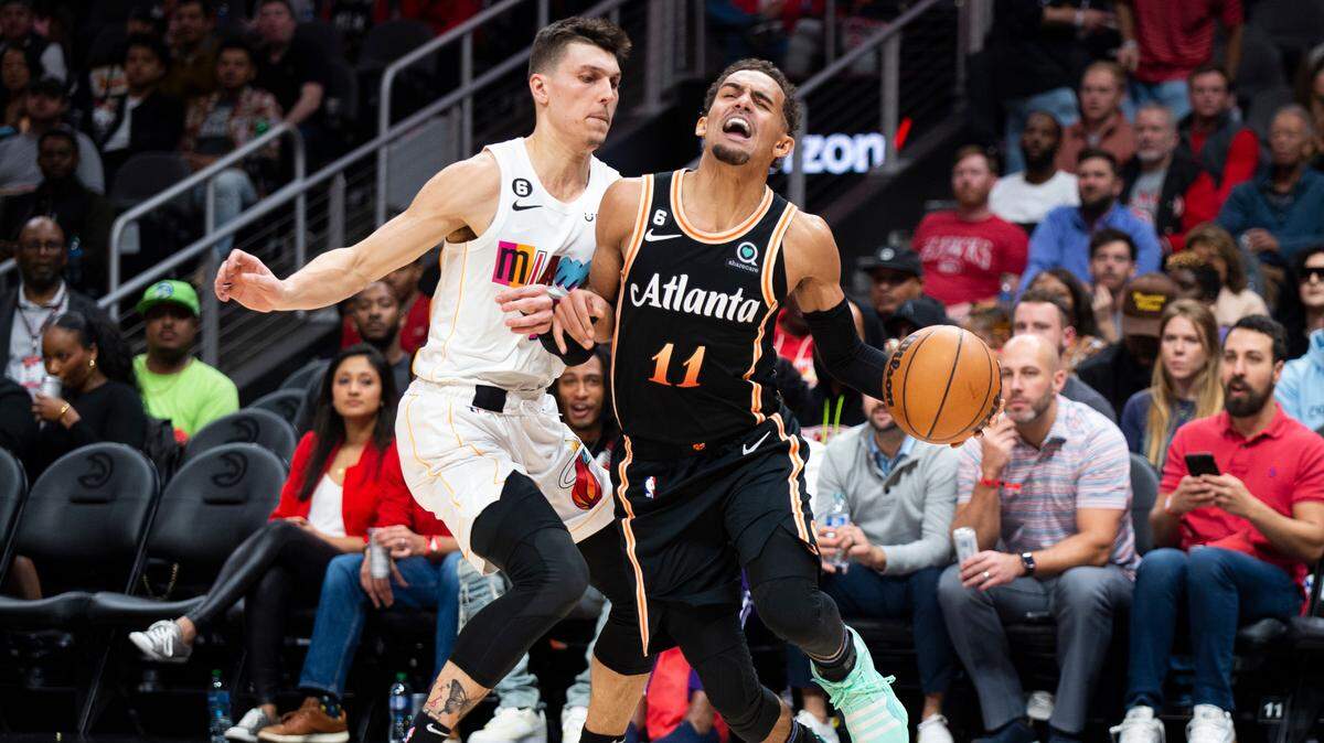 Atlanta Hawks guard Trae Young is fouled by Miami Heat guard Tyler Herro during the first half of an NBA basketball game, Sunday, Nov. 27, 2022, in Atlanta.