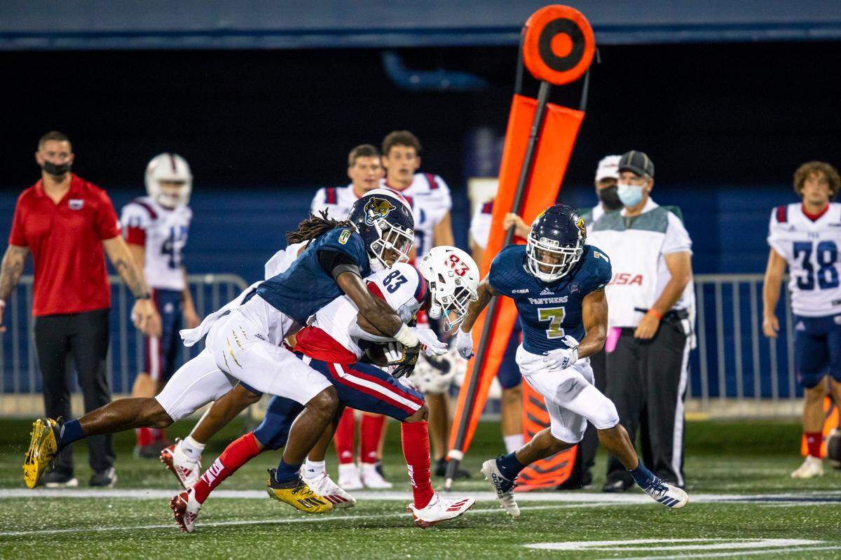 Florida International University defensive back Dorian Hall (0) tackles Florida Atlantic University wide rceiver Lajohntay Wester (83) during the first half of the ’2020 Shula Bowl’ at Riccardo Silva Stadium, in Miami, Florida, on Friday, November 13, 2020.