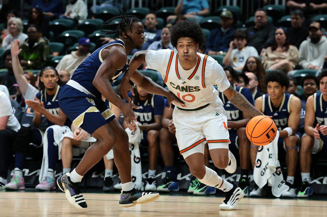 Miami Hurricanes guard Tru Washington (10) drives to the basket against FIU Panthers guard Zawdie Jackson (2) during the first half at Watsco Center on Tuesday, Dec. 16, in Coral Gables, Fla. 
