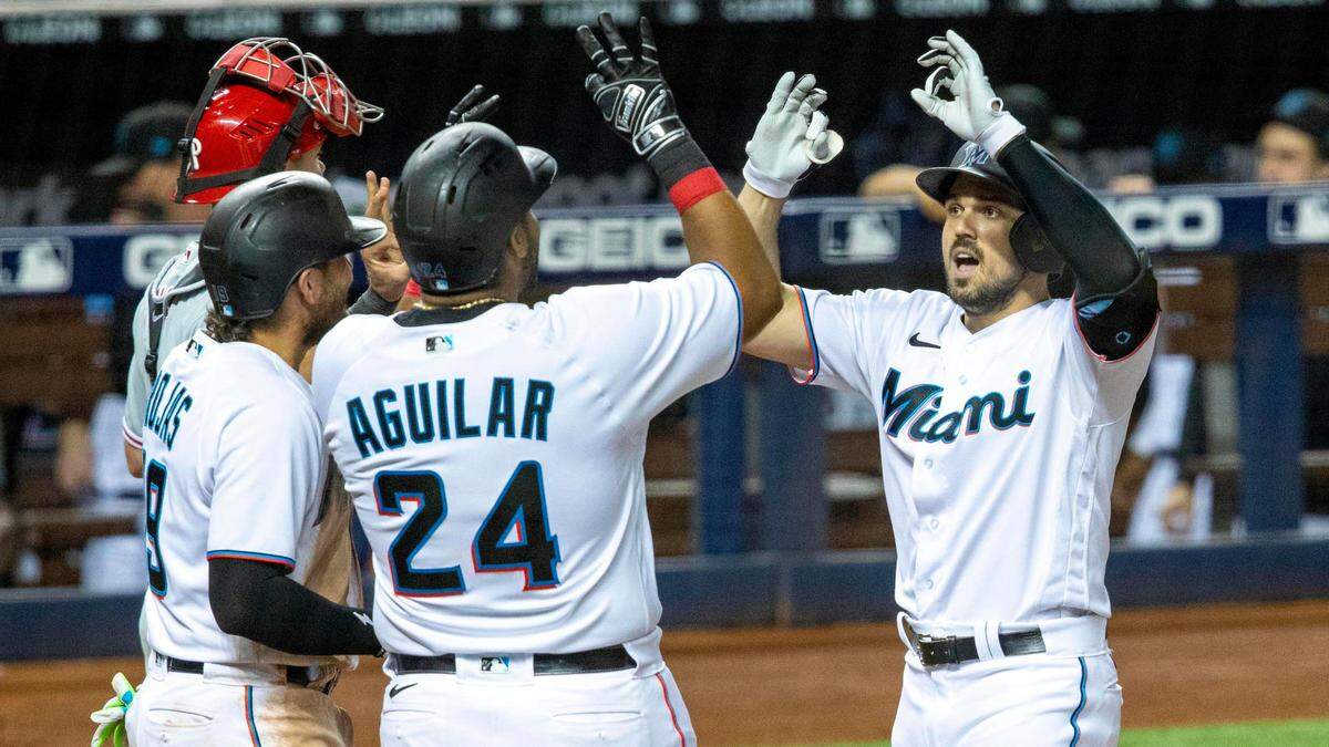Miami Marlins player Adam Duvall¬†(14) celebrates with teammates after hitting a two-run homerun during the seventh inning of an MLB game against the Philadelphia Phillies at loanDepot park in the Little Havana neighborhood of Miami, Florida, on Monday, May 24, 2021. The Marlins defeated the Phillies 9-6.
