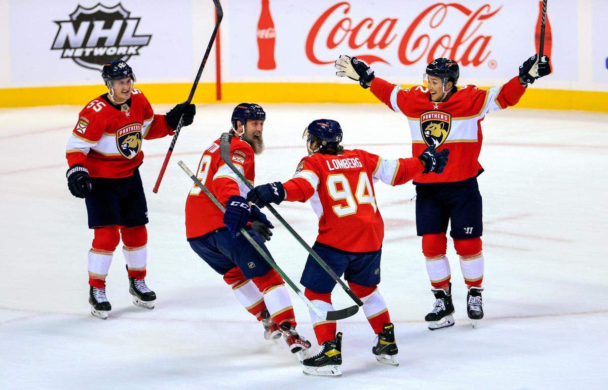 Florida Panthers left wing Ryan Lomberg (94) is congratulated by teammates Noel Acciari (55) Joe Thornton (19) Brandon Montour (62) after scoring the go ahead goal during the first period of an NHL game against the Montreal Canadiens at the FLA Live Arena on Tuesday, March 29, 2022 in Sunrise, Fl.
