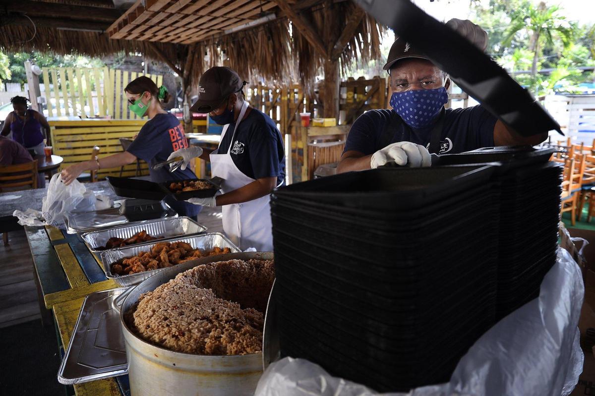 Nicky Minski, left, prepare meals as Food Rescue US volunteers along with Chef Creole staffers prepared 300 meals to help restaurant workers who were hit hard by pandemic as the non-profit teamed up with local restaurants to give out free meals to those in need on Tuesday, October 6, 2020.