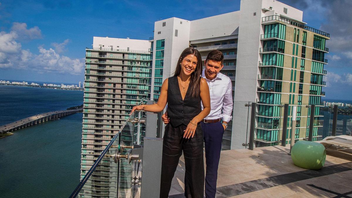 Miami-Dade remains a tough place for renters to become first-time homebuyers. Santiago Rodriguez and Alice Teodoro pose in the rooftop pool area at the Paraiso Bay Views condo building in Edgewater, where he bought a condo they’ll move into this summer.