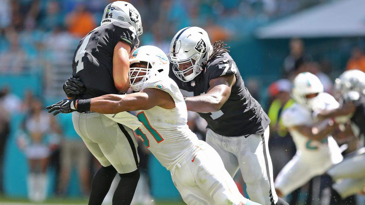 Miami Dolphins defensive end Cameron Wake (91) sacks Oakland Raiders quarterback Derek Carr (4) in the second quarter as the Miami Dolphins host the Oakland Raiders at Hard Rock Stadium in Miami Gardens on Sunday, September 23, 2018.