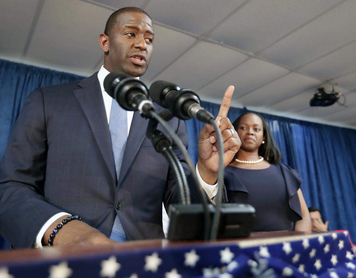 Florida Democratic gubernatorial candidate Andrew Gillum speaks to supporters as his wife, R. Jai Gillum, listens during a Democratic Party rally Friday, Aug. 31, 2018, in Orlando.