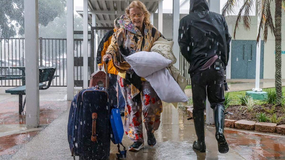 Evacuee Judith Deangelo, 79, arrives a hurricane shelter at Brookside Middle School in Sarasota, Florida on Wednesday, October 9, 2024.