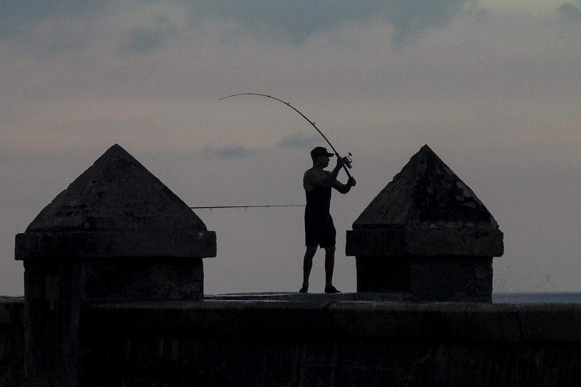 A fisherman tries to get in a last cast before the sun sets off the Malecón in Havana, Cuba.