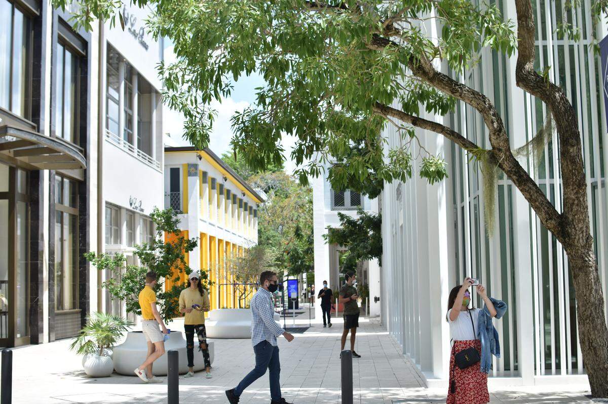 Visitors stroll along Paseo Ponti on the reopening day of the Miami Design District on Wednesday, May 20.