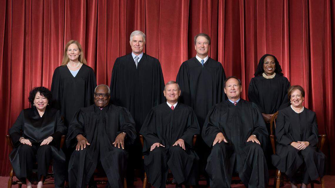 Formal group photograph of the Supreme Court as it was been comprised on June 30, 2022 after Justice Ketanji Brown Jackson joined the Court. The Justices are posed in front of red velvet drapes and arranged by seniority, with five seated and four standing. Seated from left are Justices Sonia Sotomayor, Clarence Thomas, Chief Justice John G. Roberts, Jr., and Justices Samuel A. Alito and Elena Kagan. Standing from left are Justices Amy Coney Barrett, Neil M. Gorsuch, Brett M. Kavanaugh, and Ketanji Brown Jackson. Credit: Fred Schilling, Collection of the Supreme Court of the United States