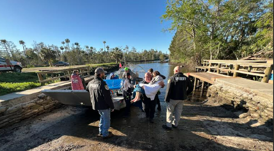 This image, shared by the Florida Fish and Wildlife Conservation Commission, shows one of the two rescued girls being carried ashore.