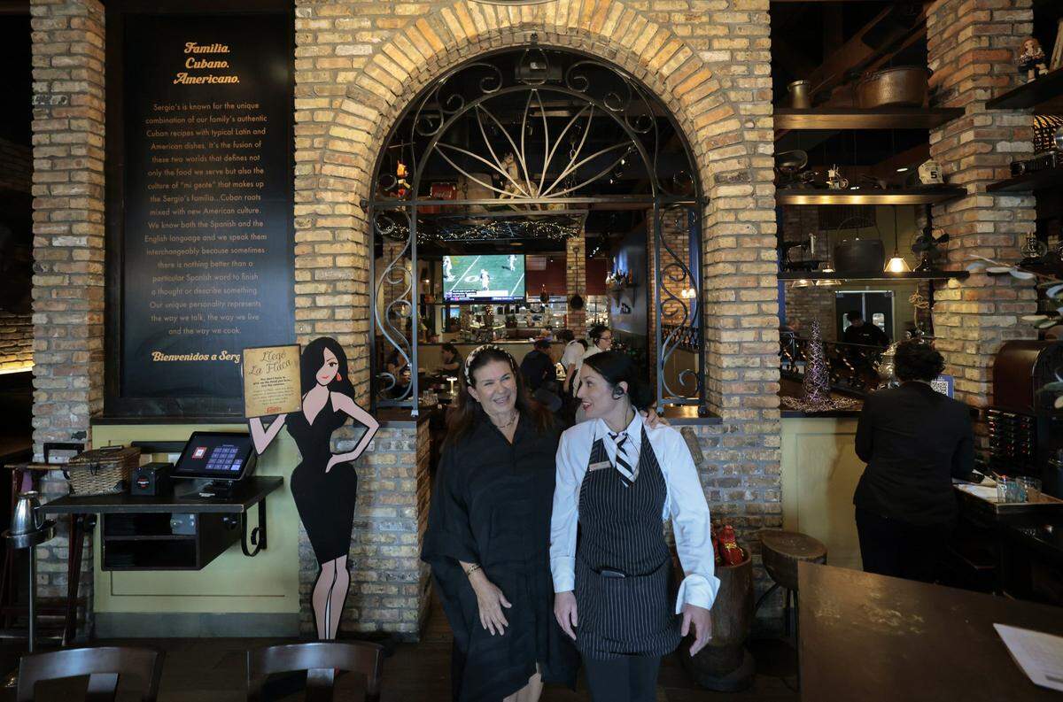 Blanca Cabrera, Founder at Sergio's restaurant walks through the lobby with a staffer at Sergio's in Kendall.The local restaurant chain is celebrating it's 50th Anniversary in Miami, Florida, on Wednesday, September 24, 2025. 