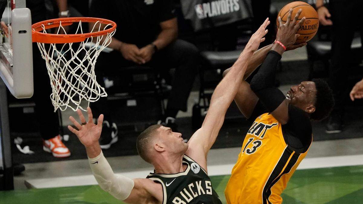Miami Heat’s Bam Adebayo shoots over Milwaukee Bucks’ Brook Lopez during the first half of Game 1 of their first-round playoff series Saturday, May 22, 2021, in Milwaukee.