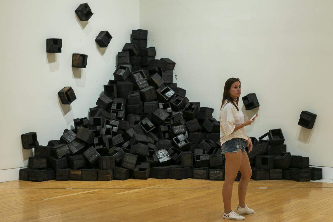 Laura Uribe, 26, looks at work from visual artist Juan Roberto Diago’s collection, “DIAGO: The Pasts of this Afro-Cuban Present,” at the Lowe Art Museum at the University of Miami in Coral Gables, Florida, on Nov. 1, 2019.