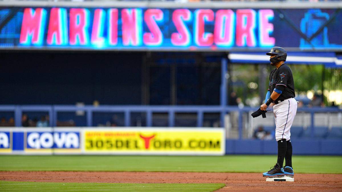 MIAMI, FL - MARCH 30: Miguel Rojas #19 of the Miami Marlins doubles for an rbi in the second inning against the Colorado Rockies at Marlins Park on March 30, 2019 in Miami, Florida. (Photo by Mark Brown/Getty Images)