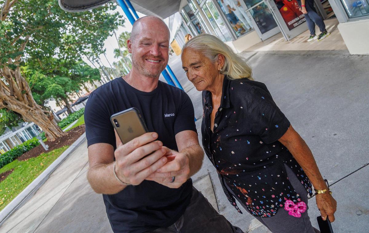 Artist Marco Cochrane posed with resident Marcela Garcia, during the unveiling of the R-Evolution™, his monumental 45-foot-tall, 32,000-pound kinetic sculpture, on Lincoln Road. The towering nude female sculpture, it is showcased on the East Coast for the first time, debuted at Burning Man in 2015.on Tuesday November 14, 2023.