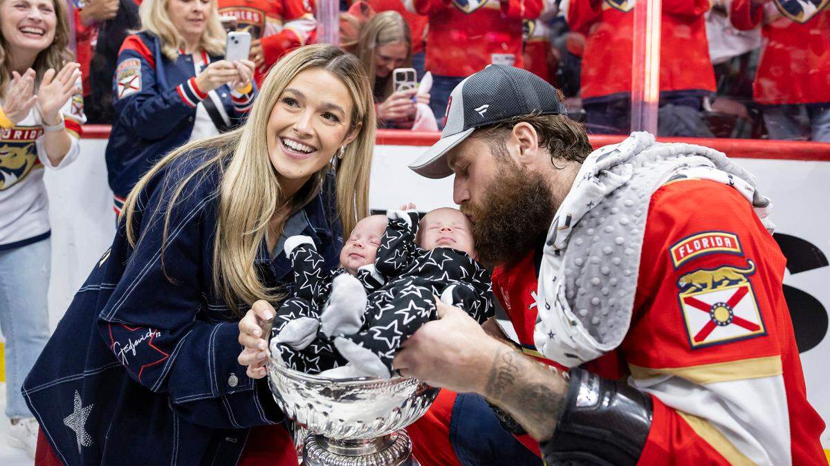 Florida Panthers left wing Jonah Gadjovich (12) with his wife, Allison, place their one-month-old twins, Lion and Adalee, in the Stanley Cup after defeating the Edmonton Oilers in Game 7 of the Stanley Cup Final at Amerant Bank Arena on Monday, June 24, 2024, in Sunrise, Fla.