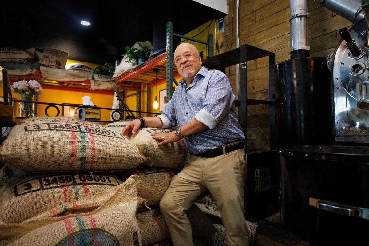 Fabio Caro, owner of Macondo Coffee, poses with bags of fresh green coffee beans during the morning on Tuesday, Feb. 18, 2025, at Macondo Coffee in Doral, Florida. The coffee beans come to the shop green, fresh and unroasted, and then are roasted at the Doral shop. This way, the taste is the same across all the Macondos in Florida.