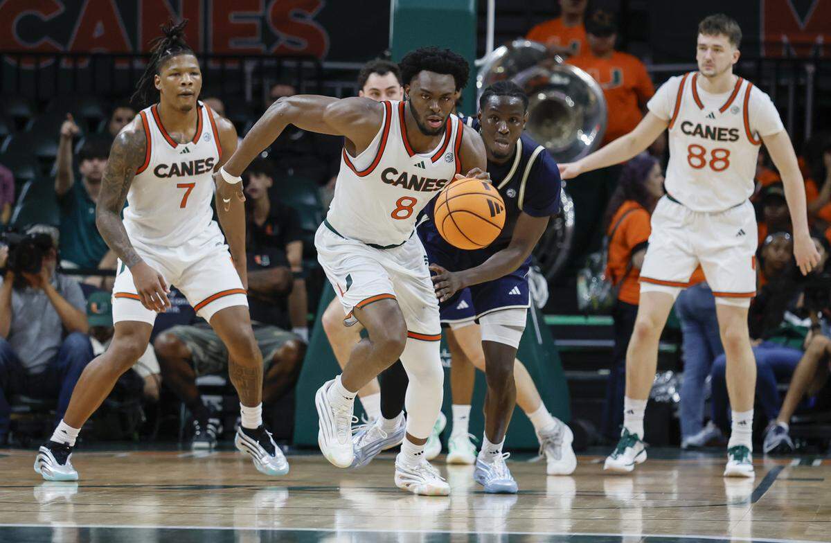 Miami Hurricanes center Ernest Udeh Jr. (8) grabs a rebound during the second half of an NCAA basketball game against the Georgia Tech Yellow Jackets at the Watsco Center on the University of Miami Campus on Saturday, January 10, 2026 in Coral Gables, Florida.