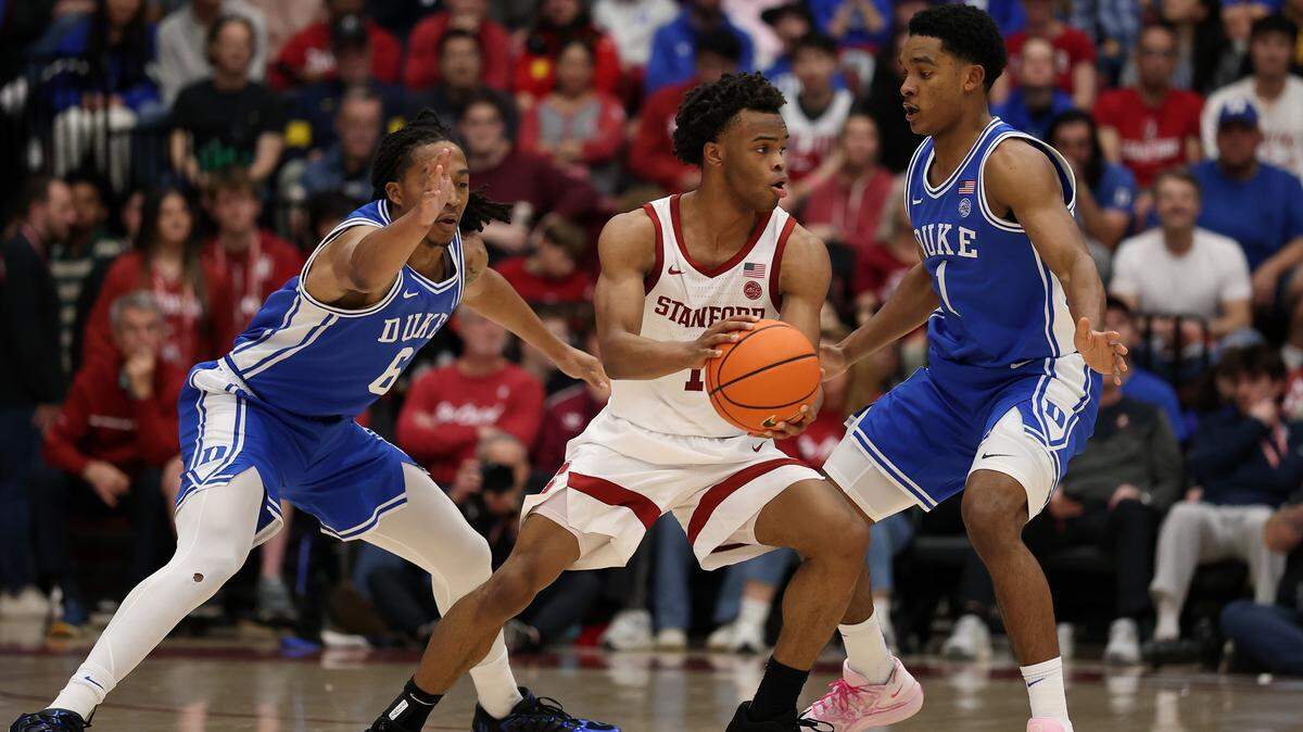 PALO ALTO, CALIFORNIA - JANUARY 17:  Ebuka Okorie #1 of the Stanford Cardinal is guarded by Maliq Brown #6 an Caleb Foster #1 of the Duke Blue Devils during the first half at Stanford Maples Pavilion on January 17, 2026 in Palo Alto, California.  (Photo by Ezra Shaw/Getty Images)