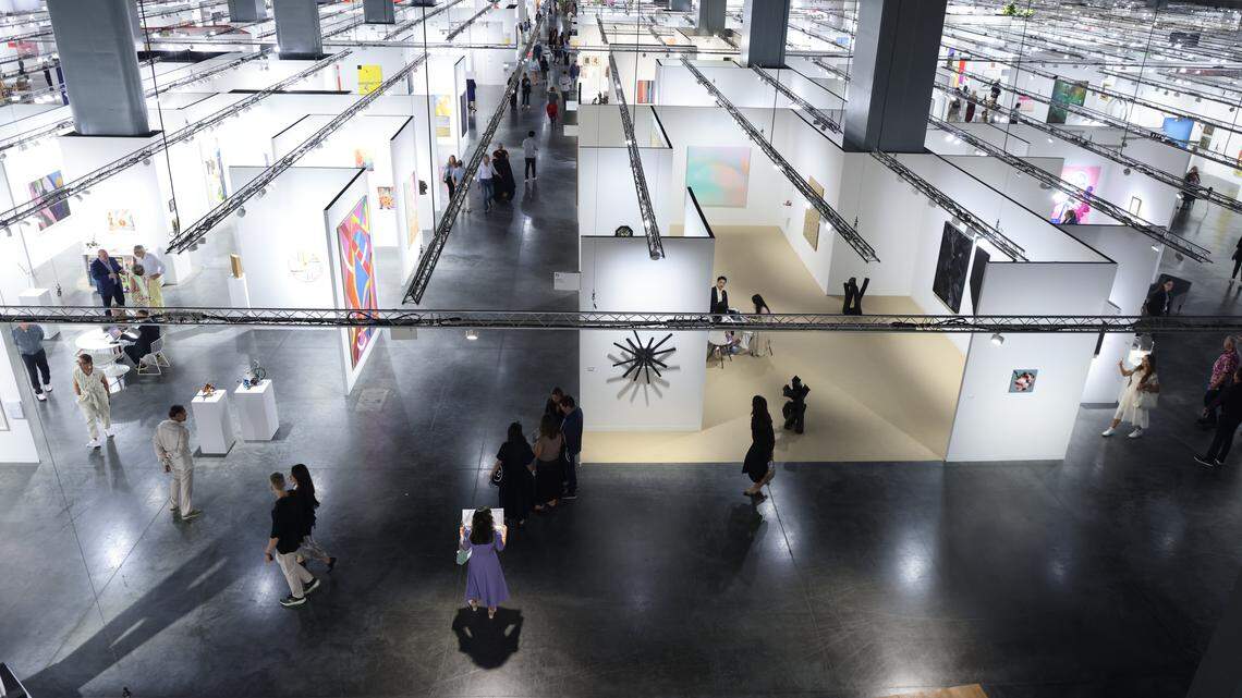 Fair goers scope the many booths of Art Basel Miami Beach on its opening day of the 23rd annual Art Basel in Miami Beach, Florida on Wednesday, December 3, 2025. The 23rd edition of Art Basel Miami Beach kicked off Wednesday as VIPs surveyed the collection of international and local galleries.