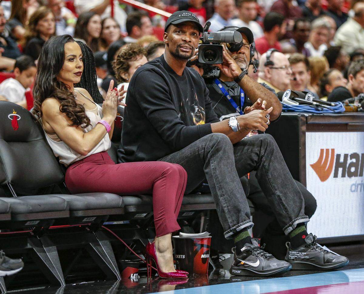 Former Miami Heat player Chris Bosh and his wife Adrienne Williams Bosh watch the game as the Miami Heat host the Washington Wizards at the AmericanAirlines Arena in Miami on Friday, January 4, 2019.