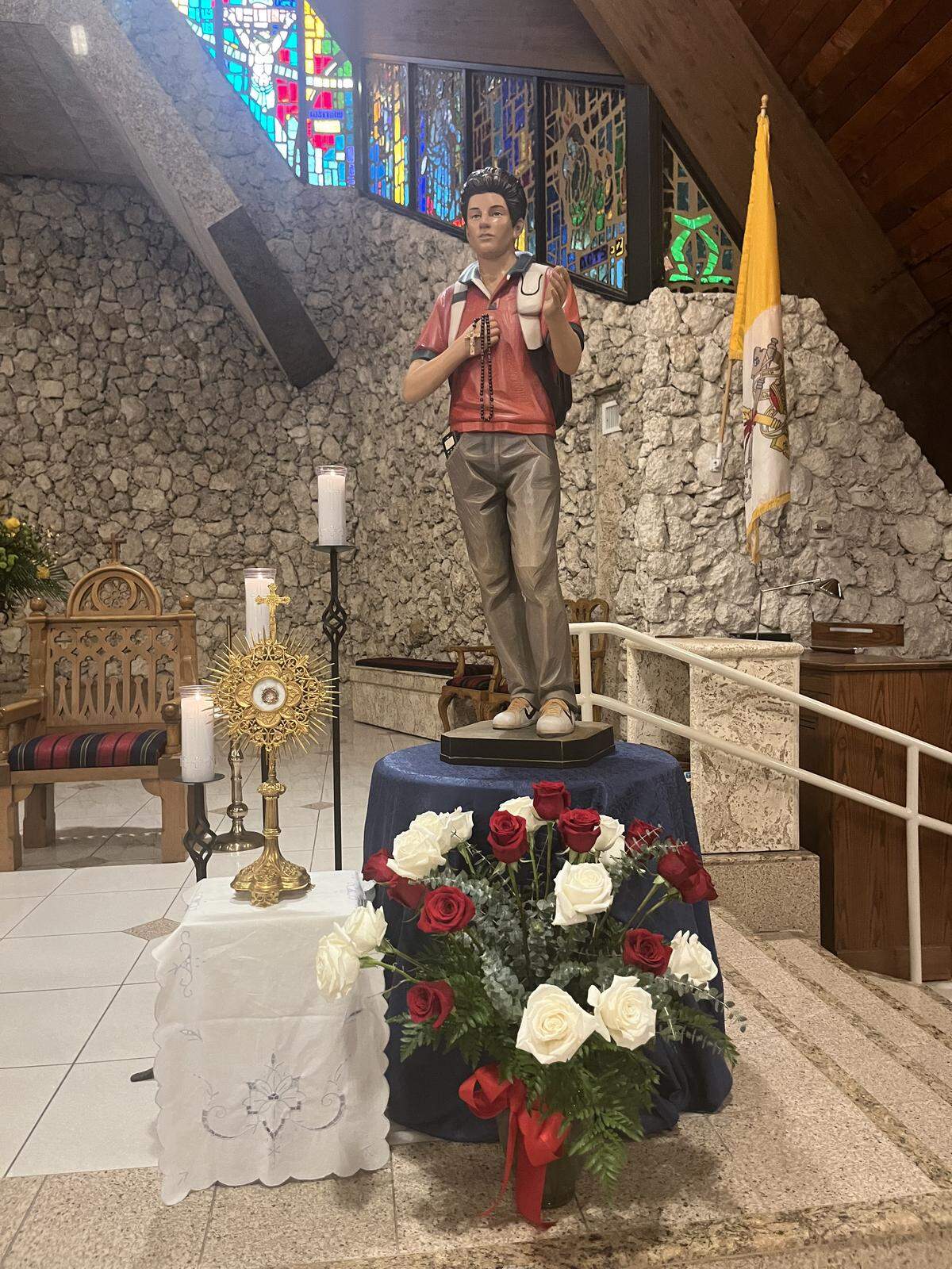 A statue and relic of Saint Carlo Acutis, the first saint from the Millennial generation, is displayed at St. David Catholic Parish in Davie ahead of Sunday mass.