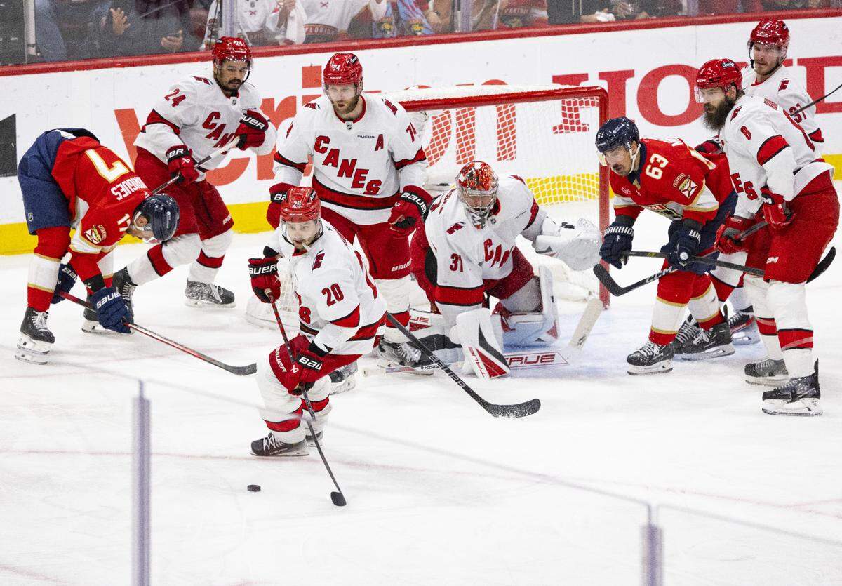 Carolina Hurricanes center Sebastian Aho (20) takes the puck away from the against the Florida Panthers in the third period of Game 4 during the Eastern Conference final of the NHL Stanley Cup playoffs at the Amerant Bank Arena on Monday, May 26, 2025 in Sunrise, Fla. The Carolina Hurricanes won 3-0.