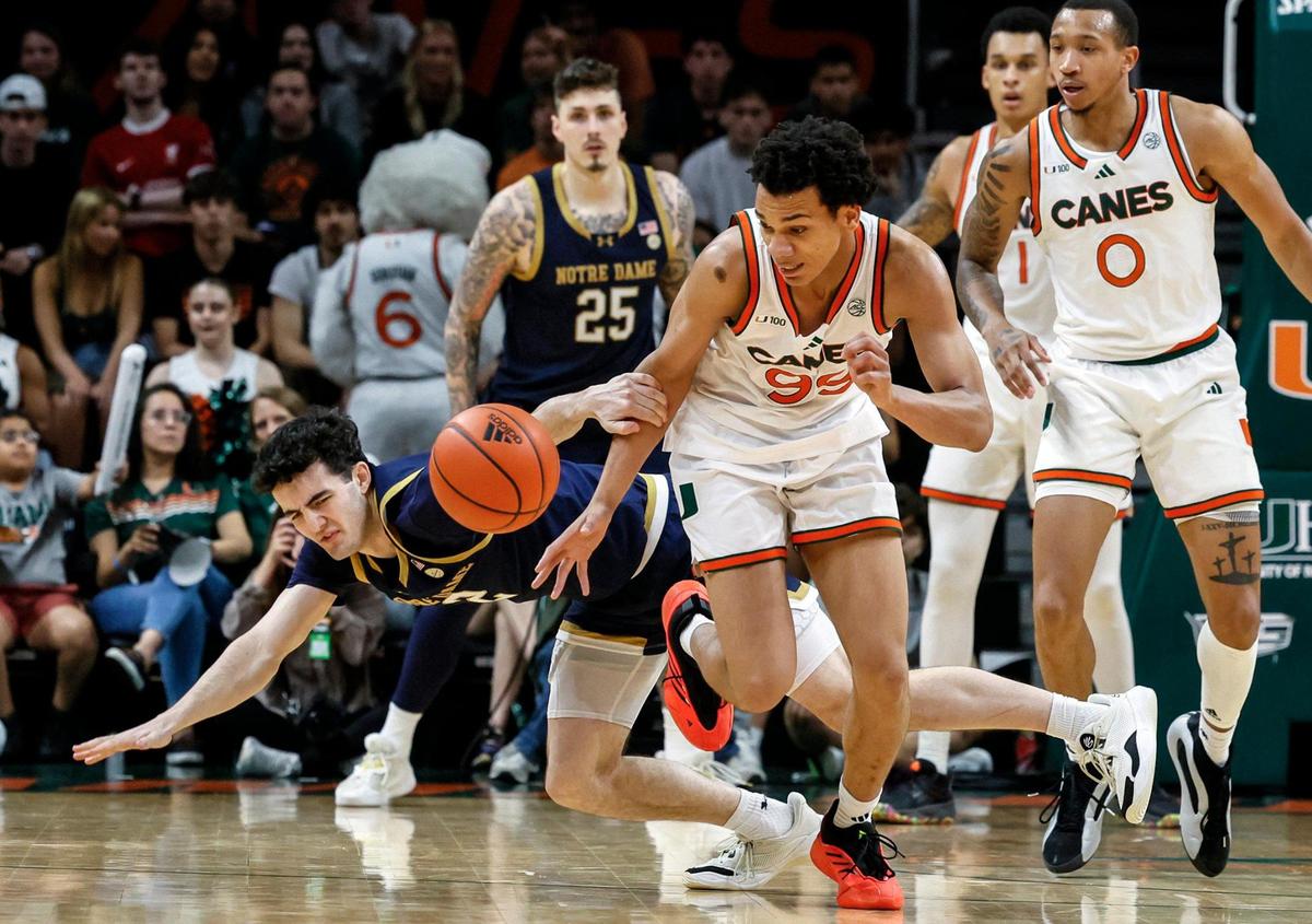 Miami Hurricanes guard Divine Ugochukwu (99) grabs the ball on a turnover by Notre Dame Fighting Irish guard Logan Imes (2) in the first half of their ACC basketball game at the Watsco Center in Coral Gables, Florida on Saturday, February 1, 2025.