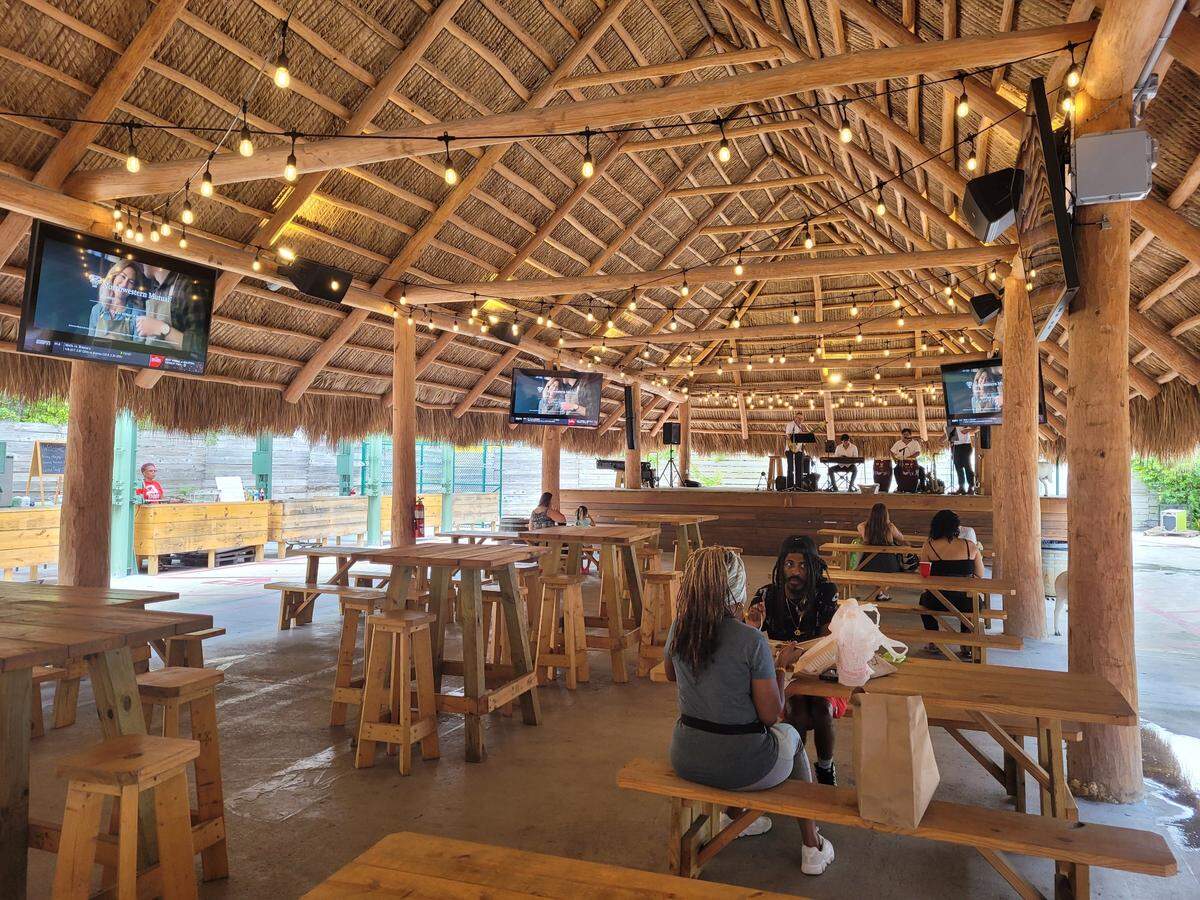 Customers can eat under cover and watch TV at one of four new tiki huts on the property.