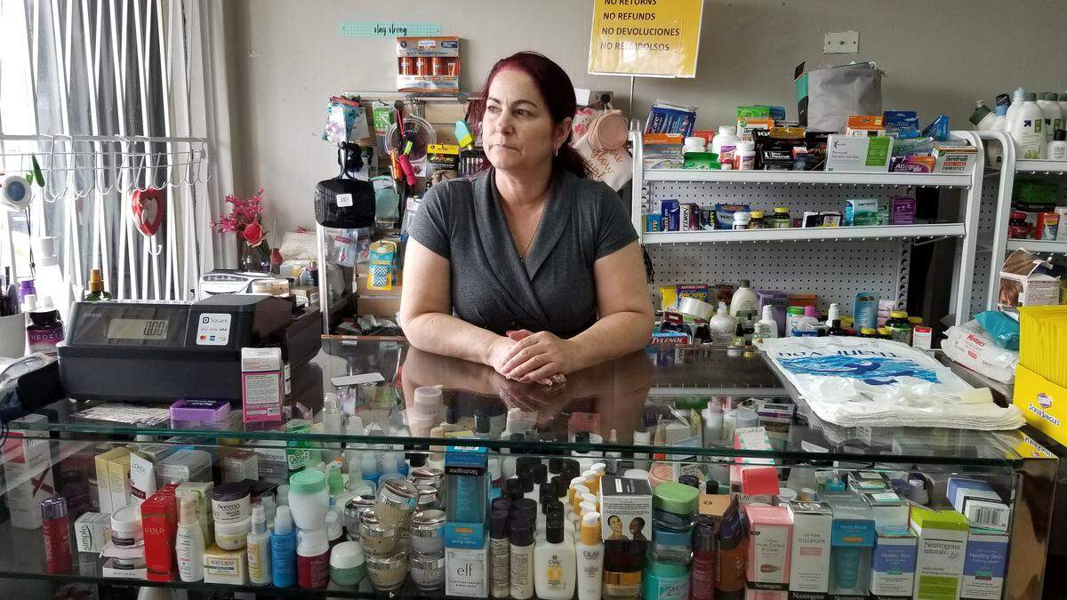 Eunice Miranda stands behind the counter of Miranda’s Discount Store, the West Perrine shop she owns with her husband, on Tuesday March 17, 2020.